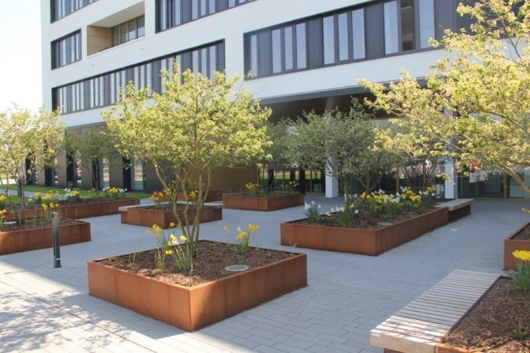 Business courtyards installing Corten Steel planters for biophilic design